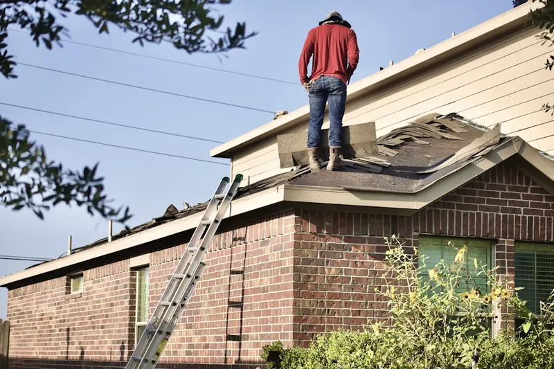 Professional roofer working on a residential roof in Penitas
